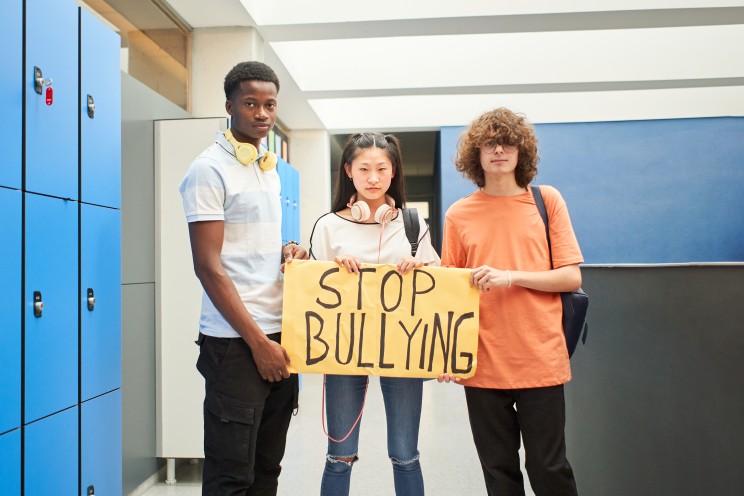 a-group-of-students-display-a-banner-with-the-phra-3UHTB23 (1)